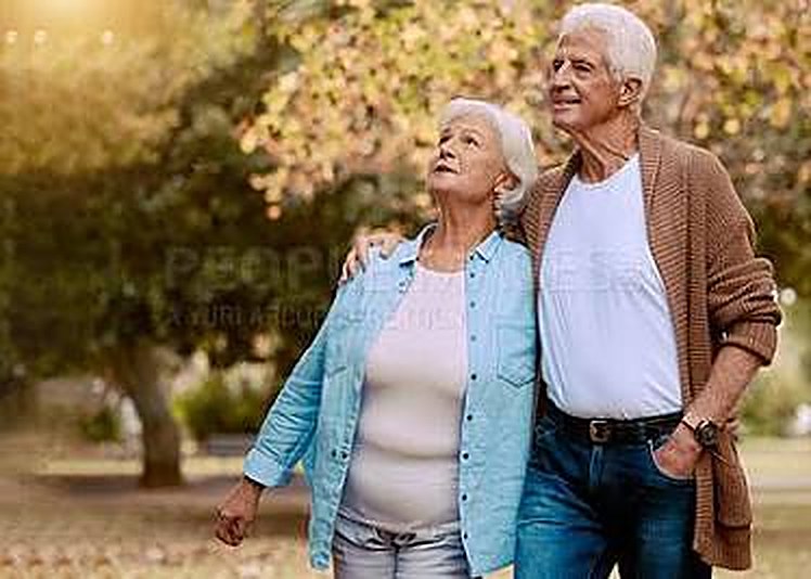 A senior couple walking together outdoors